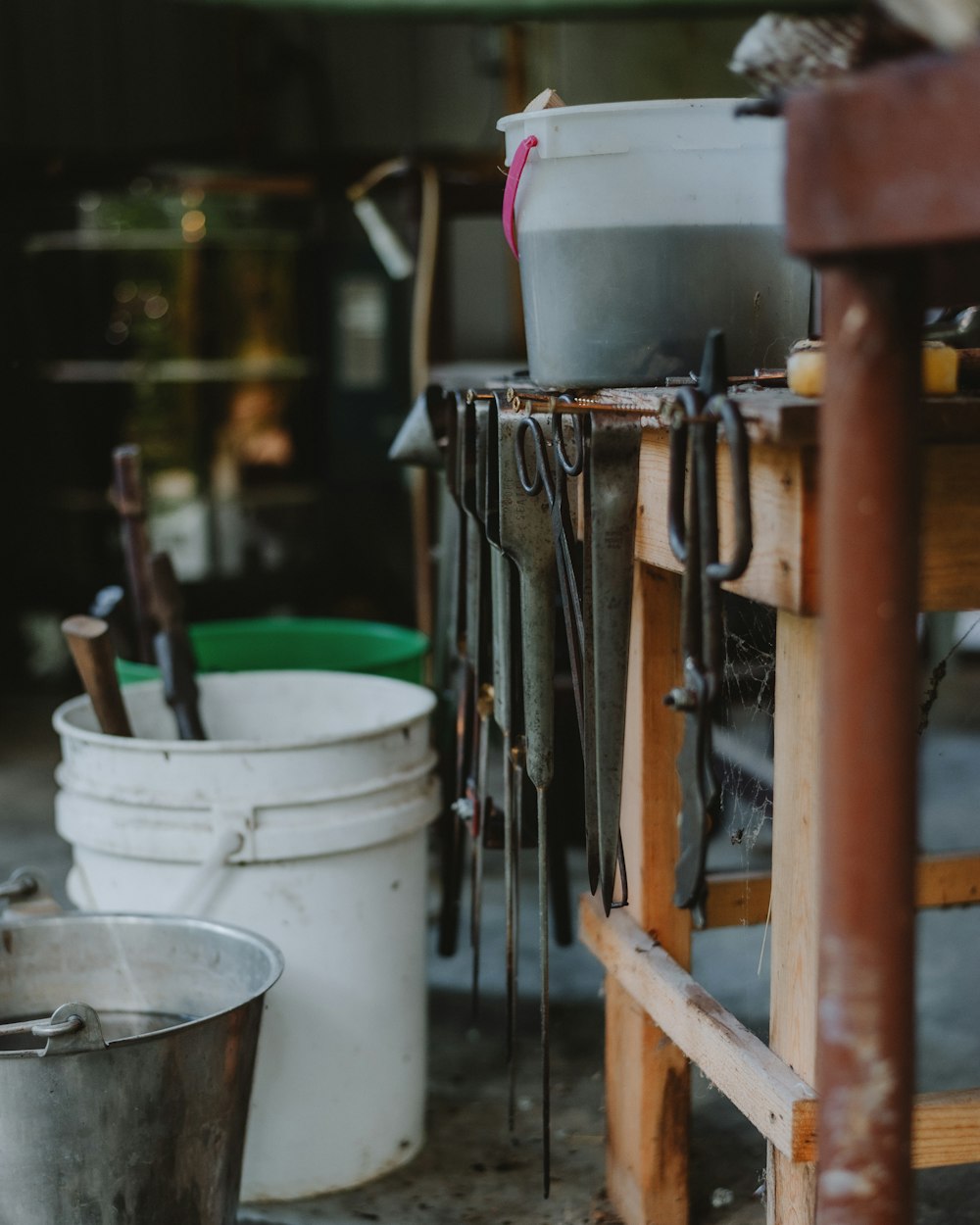 a number of buckets and tools on a table