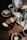 Slices of cake are arranged on rustic plates and a black tray, surrounded by cups of coffee, a Chemex coffee maker, a white pitcher, and a small vase with green leaves and flowers on a wooden table. A bag of coffee beans and a linen cloth add a cozy touch.