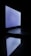 A laptop is open in a dark environment with its screen glowing and its reflection visible on the surface below.
