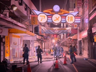 Technicians installing lighting and signaling systems on a busy urban street.