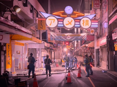 Technicians installing lighting and signaling systems on a busy urban street.