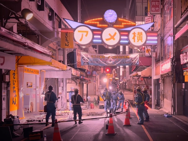 Construction workers installing lighting systems on a busy urban street.