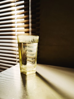 A serene glass of purified water catching sunlight on a clean countertop