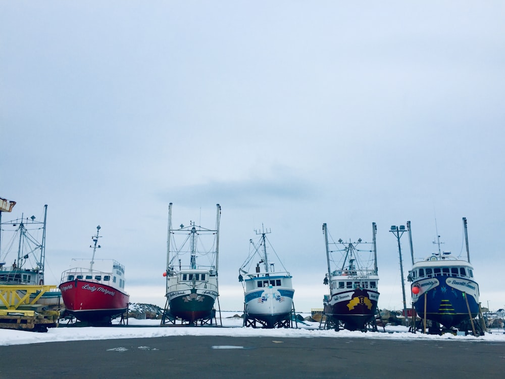 a bunch of boats that are sitting in the snow