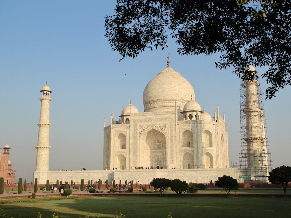 a large white building with two towers in front of it