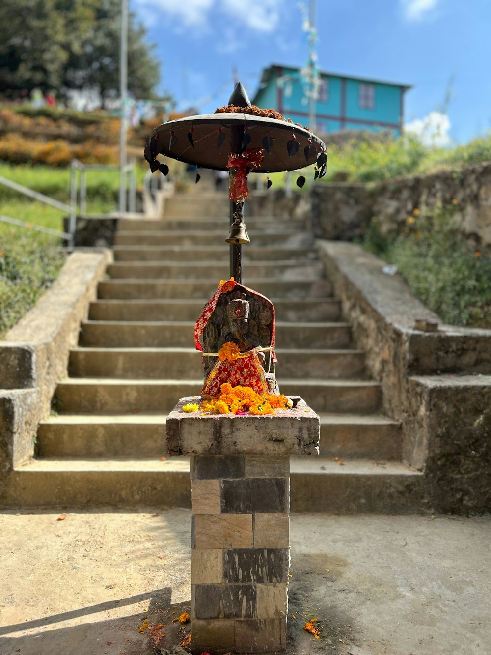 a statue of a person sitting on top of a set of stairs