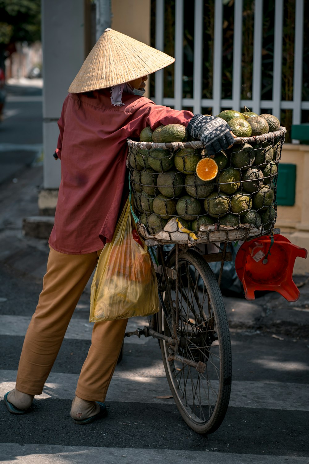 a person on a bike with a basket of fruit