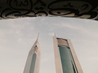 a couple of tall buildings sitting next to each other