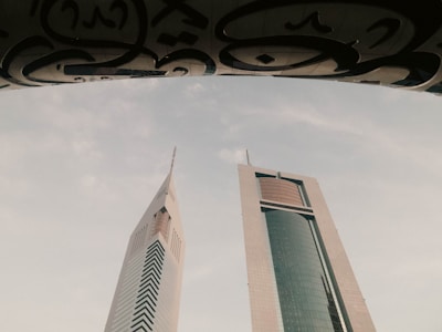 a couple of tall buildings sitting next to each other