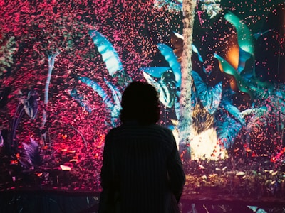 A glowing digital avatar standing in a serene metaverse garden at sunset.