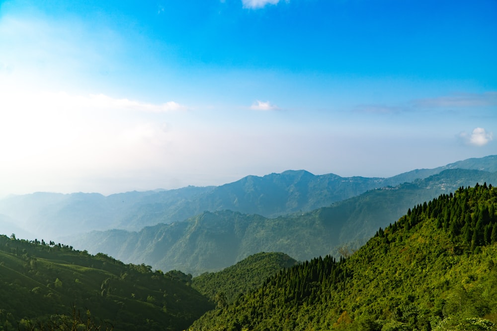 a scenic view of a mountain range with a blue sky