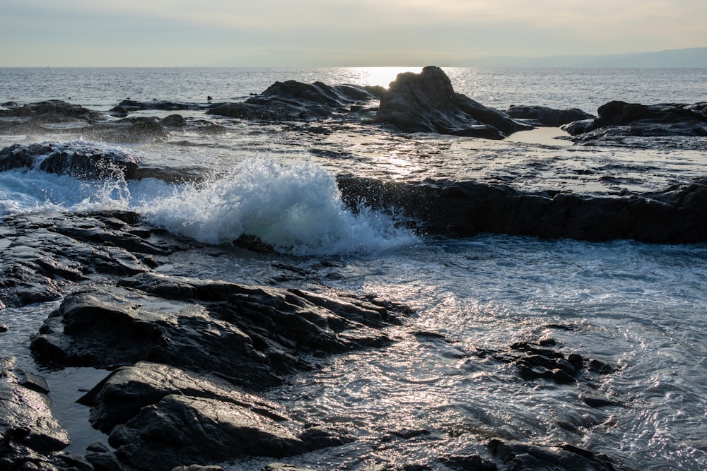 a body of water near a rocky shore