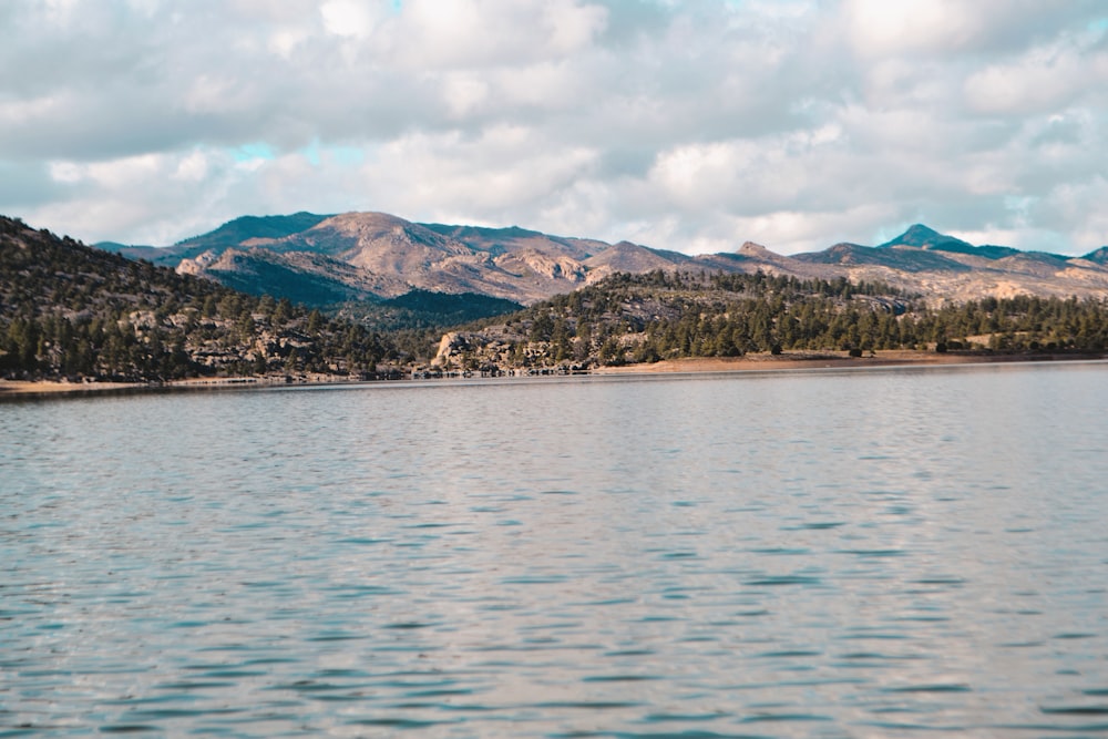 a body of water with mountains in the background