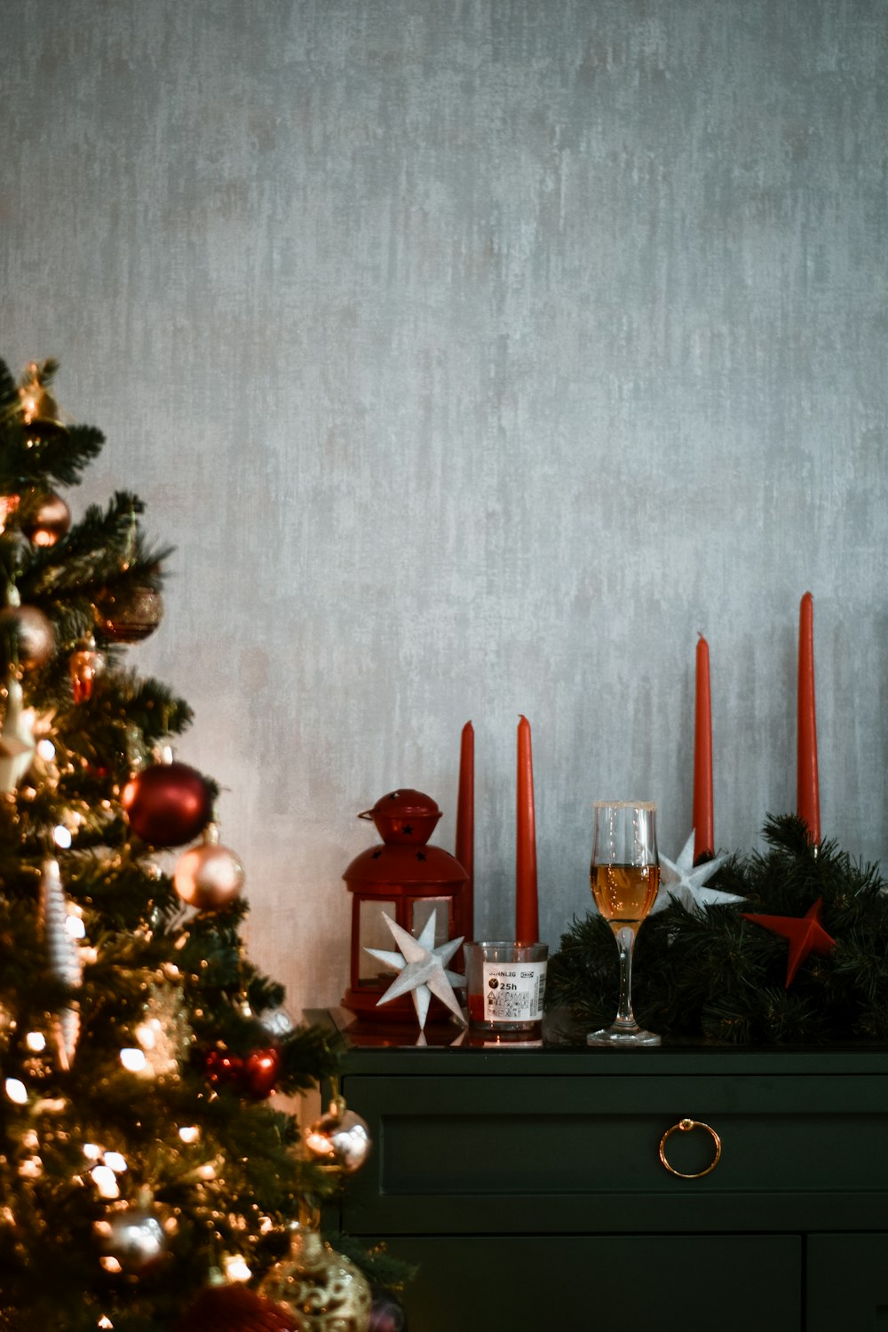 a christmas tree with red candles and decorations