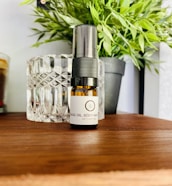 Beautifully crafted Ayurvedic oil bottles and soaps set against a natural backdrop of green leaves and soft sunlight.