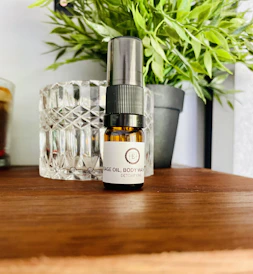 Close-up of soothing massage oils with minimalistic black and white packaging on a clean white surface.