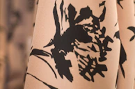 A close-up of a colorful floral print with delicate brushwork and texture.