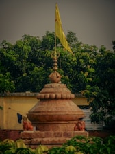 a statue with a yellow flag on top of it