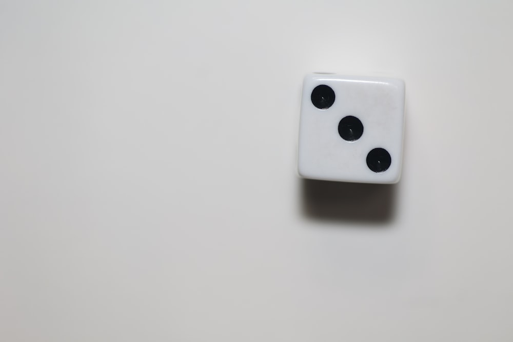 a white dice sitting on top of a table
