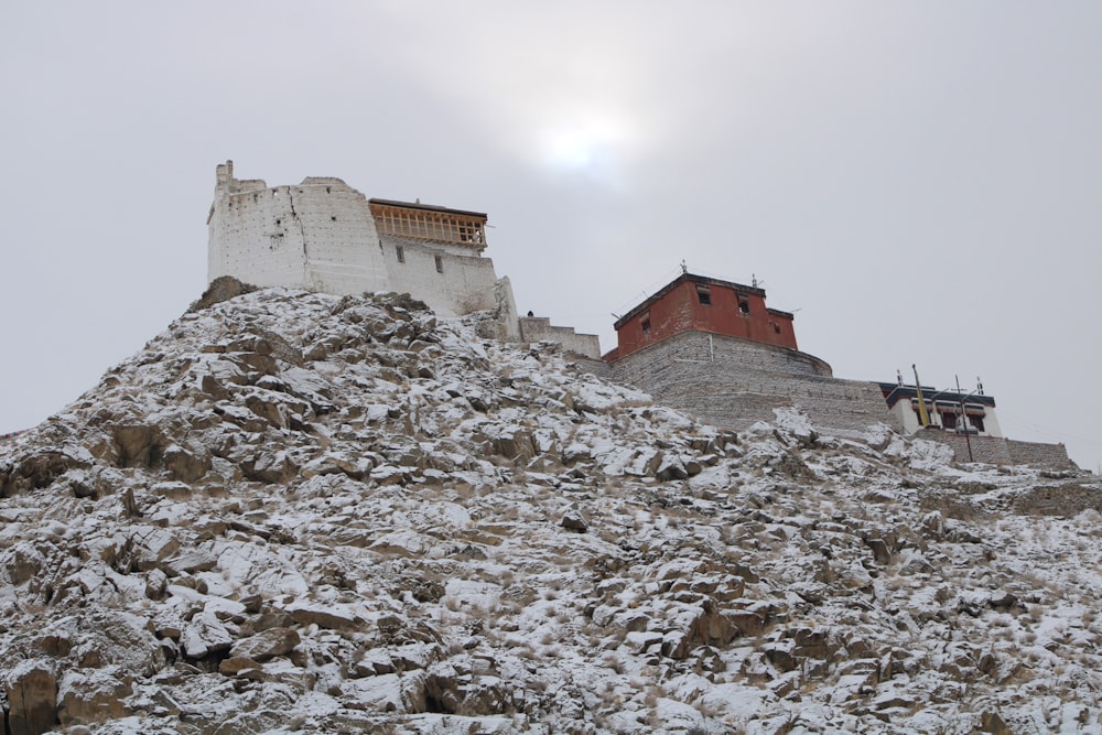 a mountain covered in snow with a building on top of it