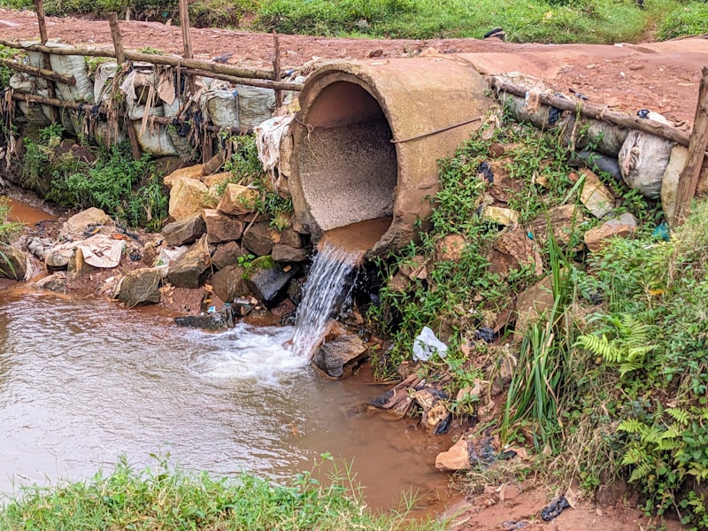 A large pipe discharging water into a stream