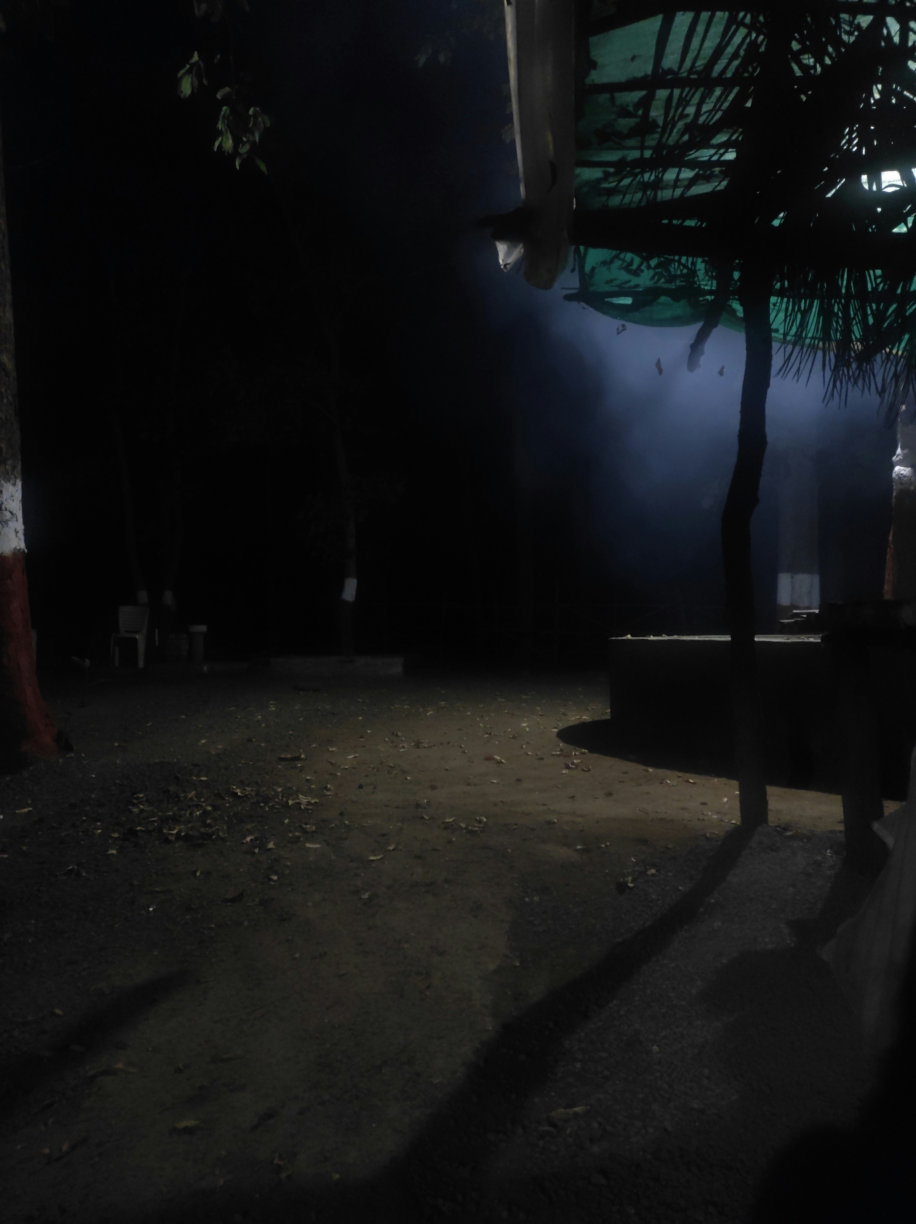 a person sitting on a bench in the dark