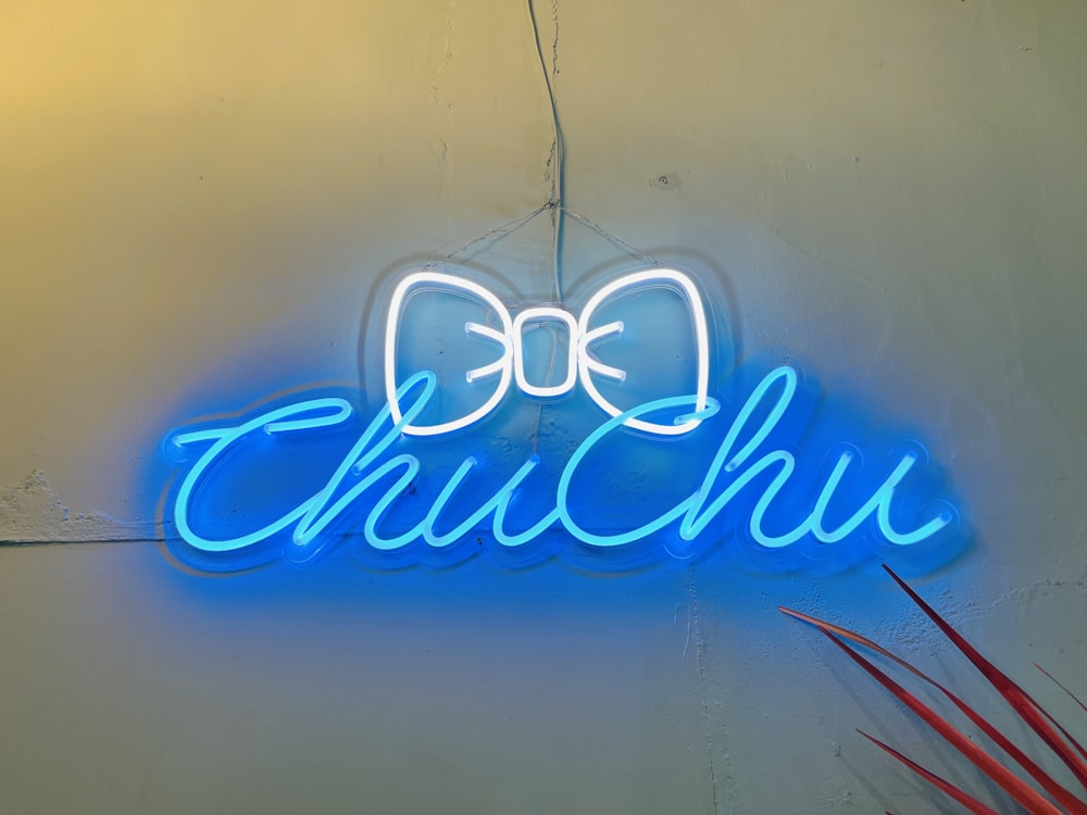 a neon sign with a bow on it