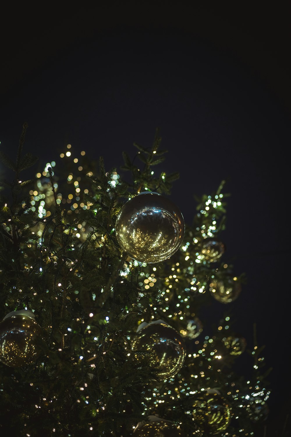 a close up of a christmas tree with ornaments on it