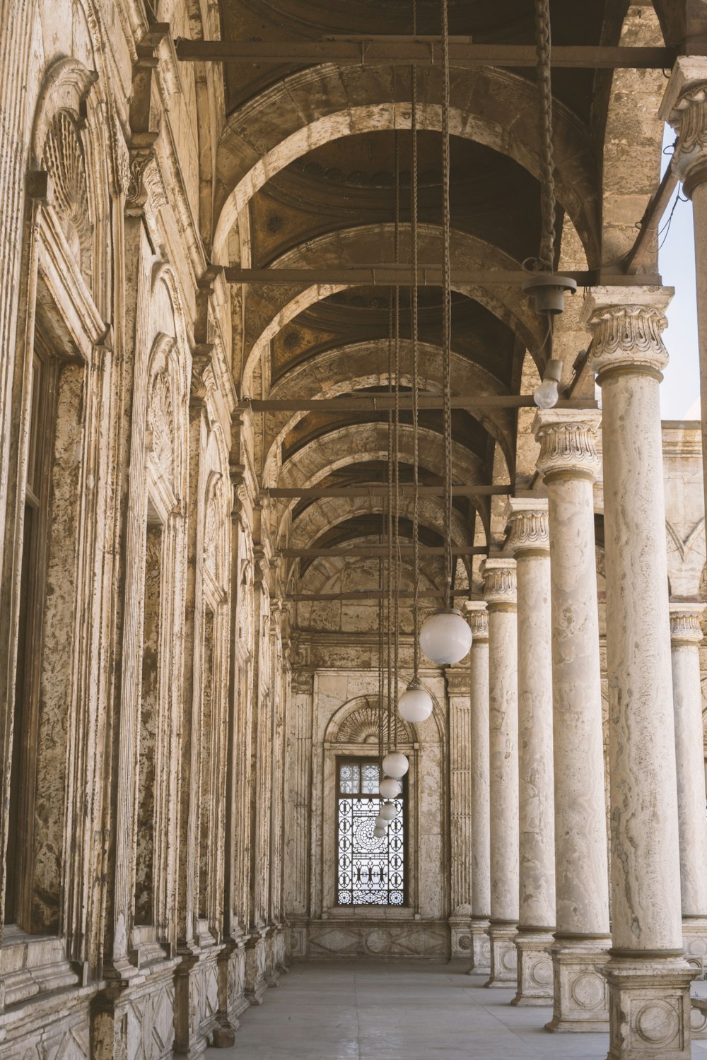 a building with columns and a clock on the wall