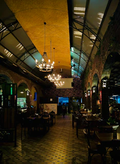 A vibrant restaurant interior designed with warm lighting and modern rustic elements.