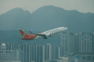 Airplane taking off over a city skyline, representing fast and reliable air freight services.