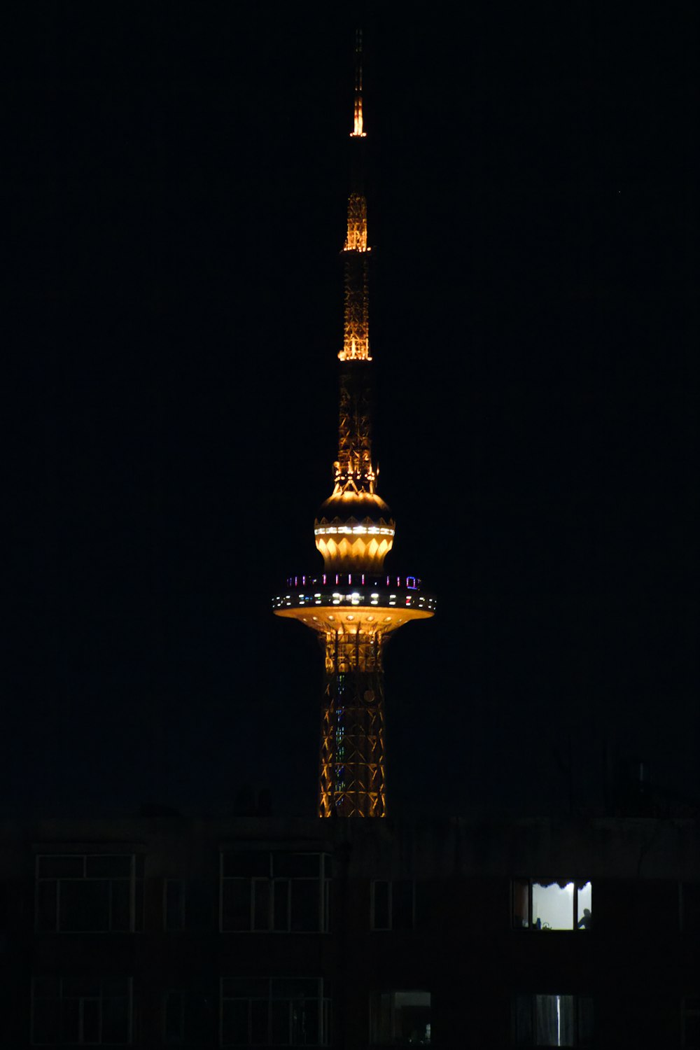 a very tall tower lit up at night