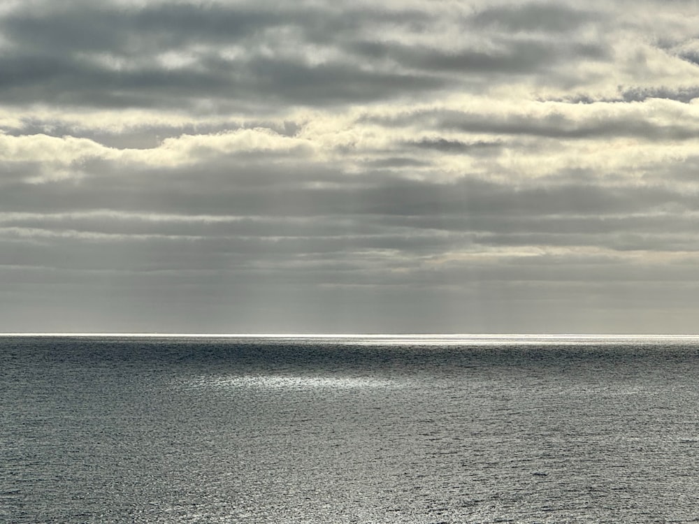 a large body of water under a cloudy sky