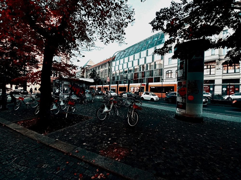 a group of bicycles parked on the side of a road