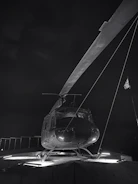 Technician inspecting helipad lighting system at dusk