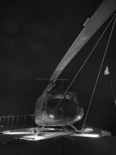 Technician inspecting helipad lighting system at dusk