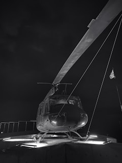 An air ambulance helicopter ready for takeoff, spotlighted under airport lights.