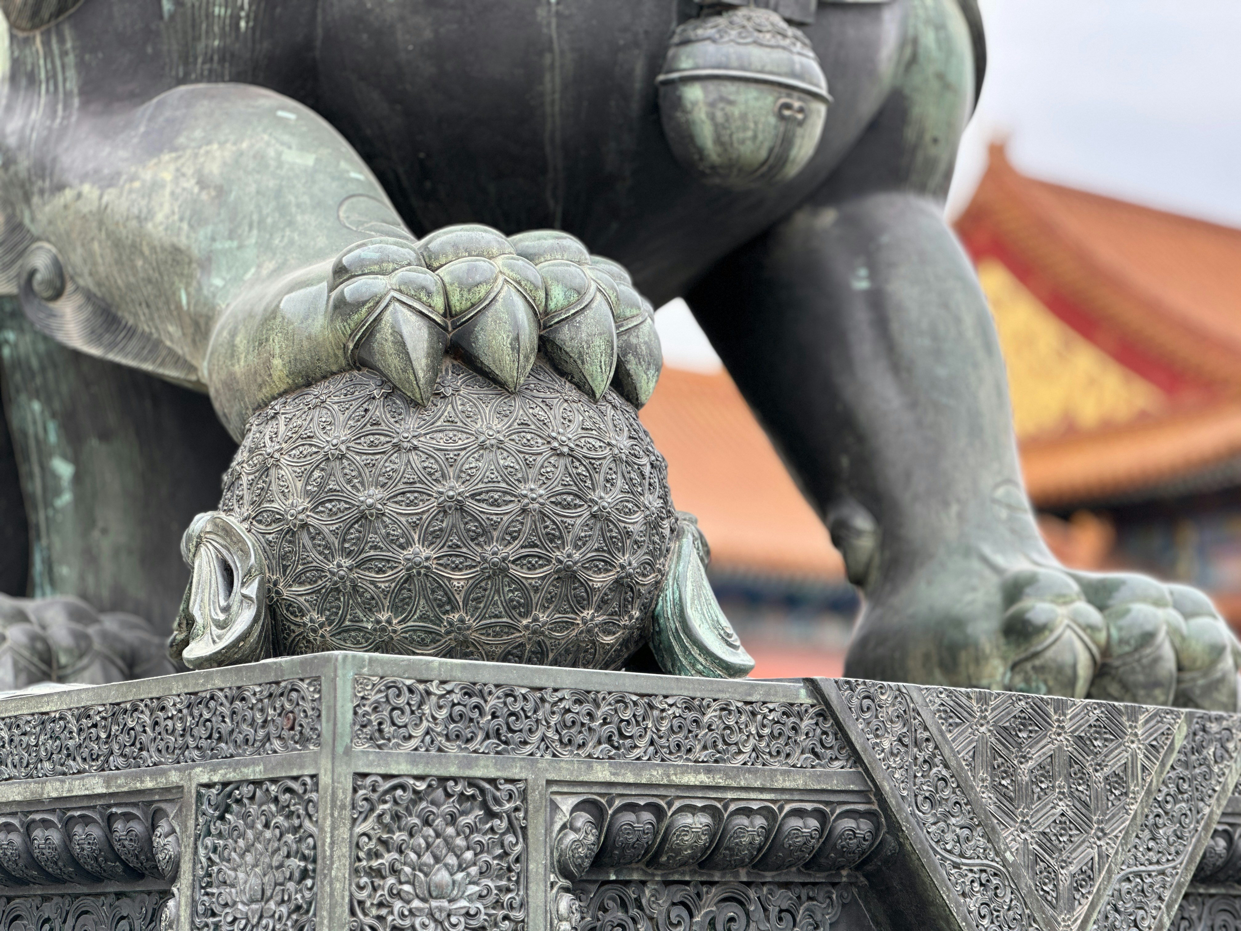 a close up of a statue of a person holding a ball