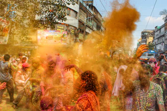 A vibrant street scene in Mathura with traditional buildings and locals celebrating a cultural festival.