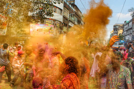 A vibrant street scene in Mathura with traditional buildings and locals celebrating a cultural festival.