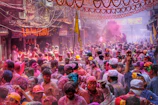 A vibrant street scene during a local festival, full of colorful decorations and joyful people.