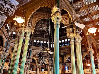a large building with columns and lights inside of it