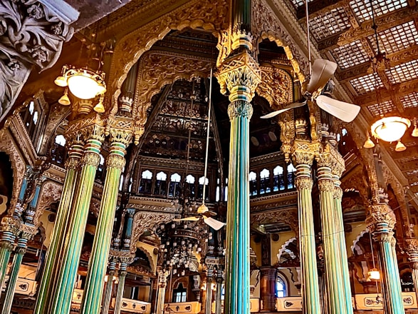 a large building with columns and lights inside of it
