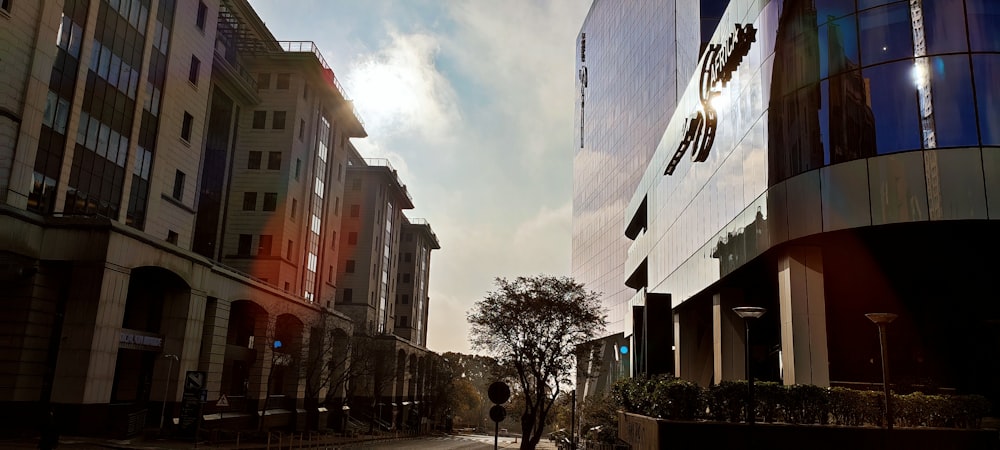 a person walking down a street next to tall buildings