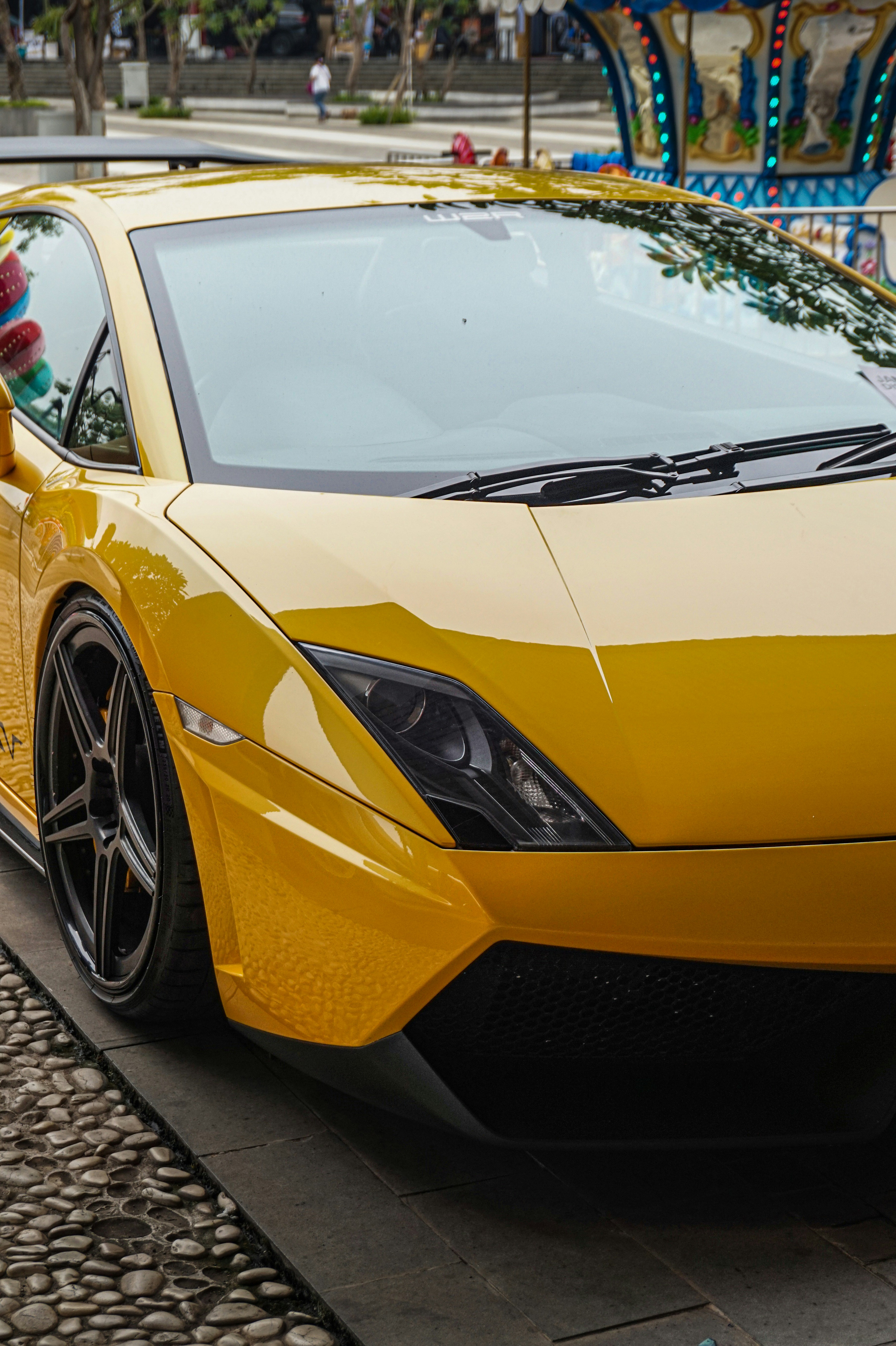a yellow sports car parked on the side of the road