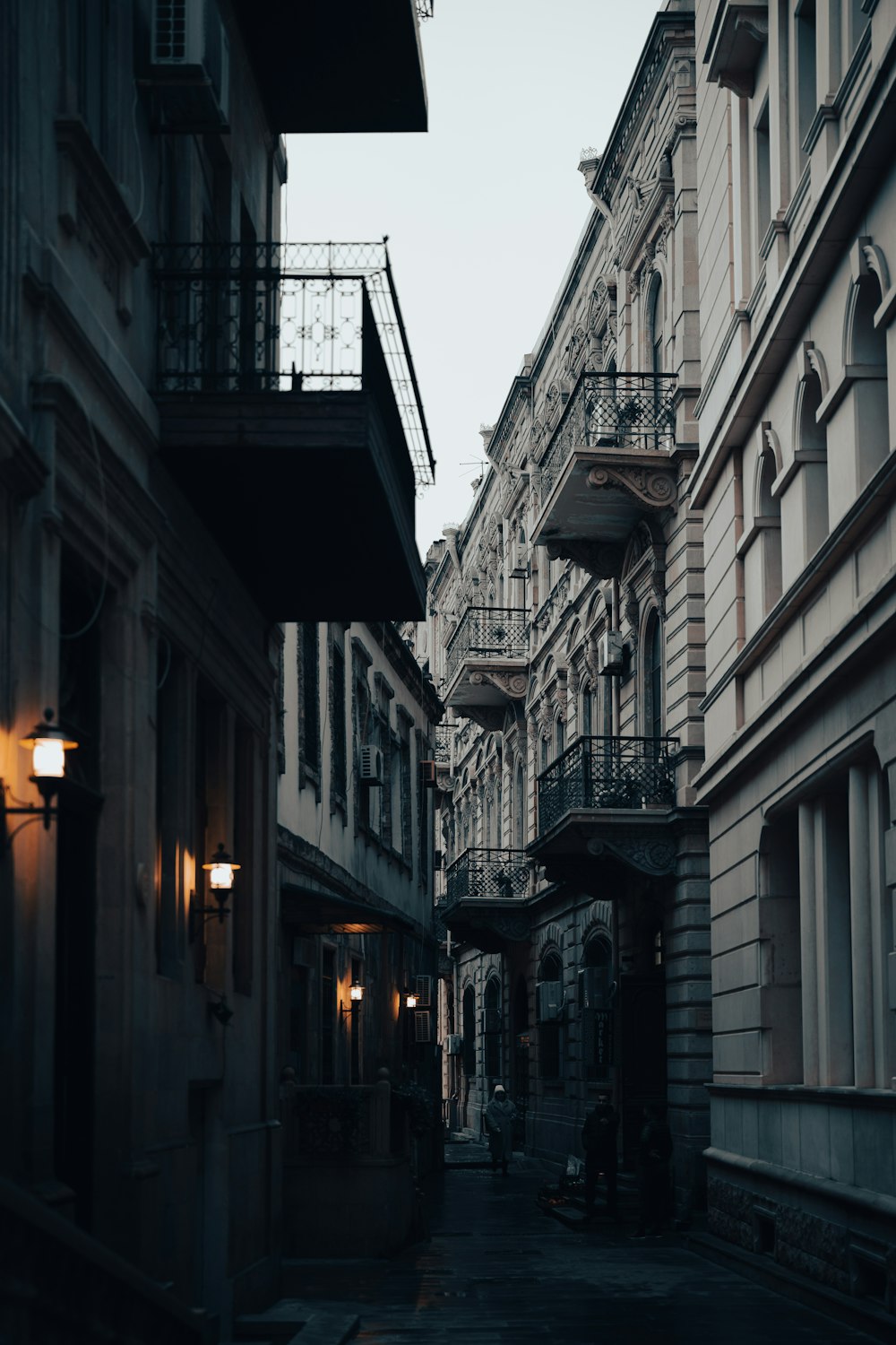 a narrow city street lined with tall buildings