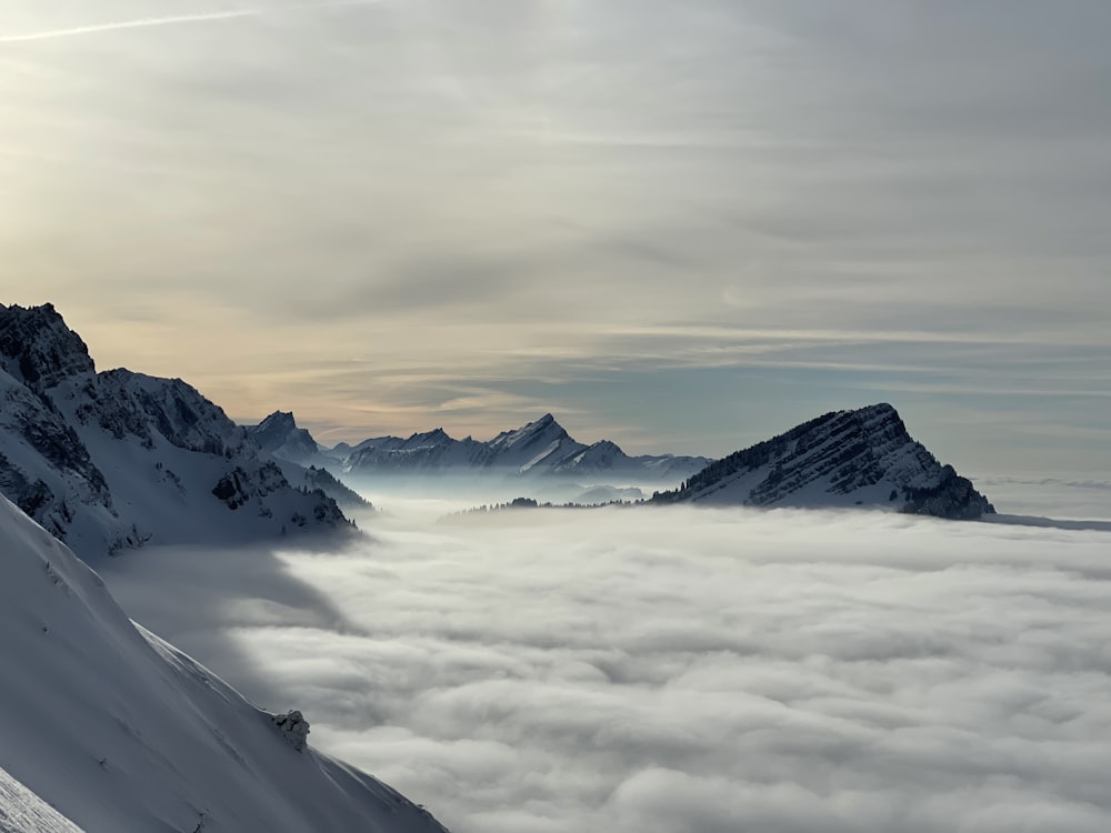 a view of a mountain range covered in clouds