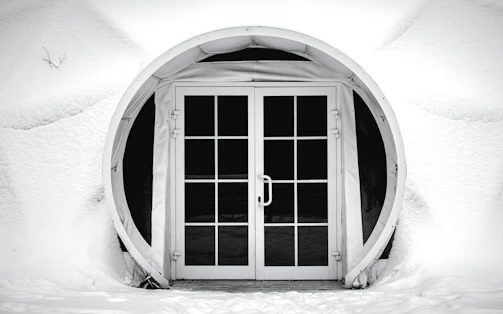 Wide shot of a luxury villa entrance featuring dimansi doorbell with cinematic lighting and snowfall effect