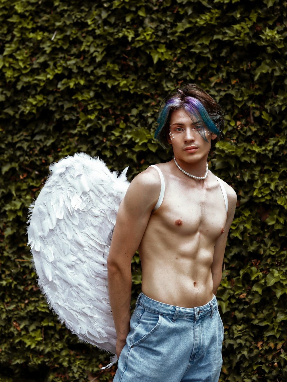 a shirtless man with an angel wings on his chest