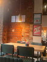 A cozy café scene with customers enjoying artisanal dishes, framed by matte forest green walls.